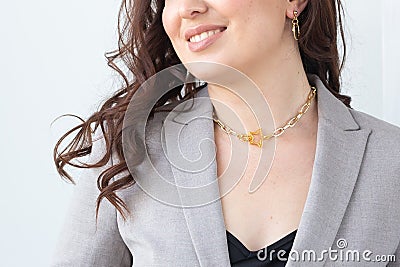 Close up attractive female model gold necklace and earrings. Woman wearing jewellery. Jewellery photo for e commerce and Stock Photo