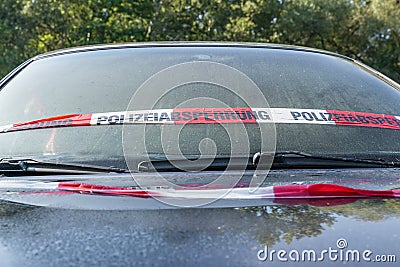 Close up of an Audi A3 after an accident with police barrier tape with German word for police barricade, Germany Stock Photo