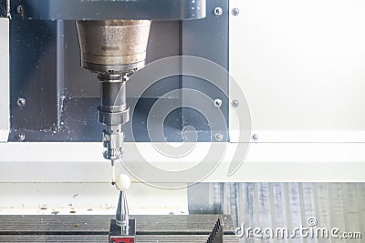 Close up automatic coordinate measuring probe during calibrate with standard ball for inspection dimension work piece or product Stock Photo