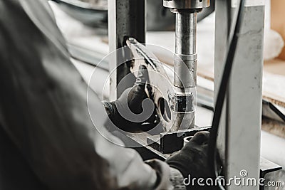 Close up of automechanic changing the silent block in the hydraulic press in the car service Stock Photo