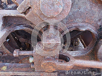 close up of an axle and rods on old rusted abandoned industrial machinery Stock Photo