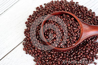 Close up of azuki beans in wooden scoop on white table background Stock Photo