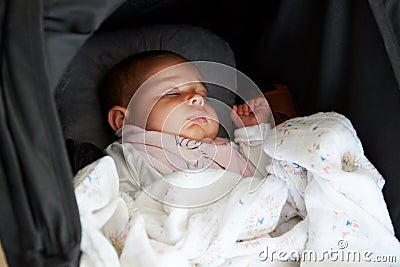 Close Up Of Baby Girl Asleep In Detachable Seat Stock Photo