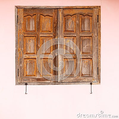 Old wooden windows with pink concrete walls Stock Photo