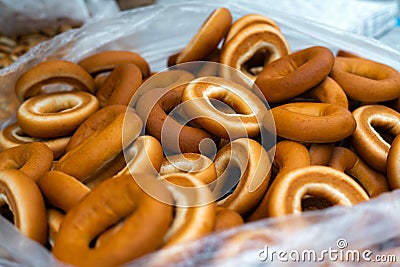 Close up of bagel buns at holiday fair. Bunch of sweet ring bun pastry for sale Stock Photo