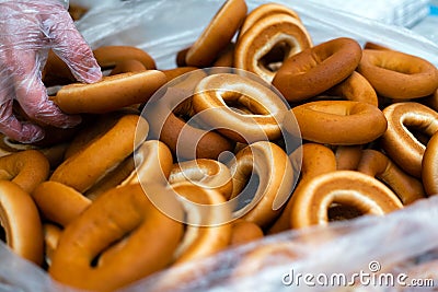 Close up of bagel buns at holiday fair. Bunch of sweet ring bun pastry for sale Stock Photo