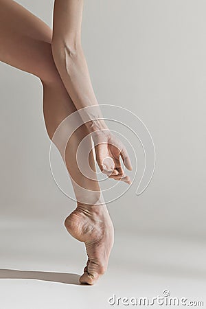 Close-up ballerina`s legs on the white floor Stock Photo