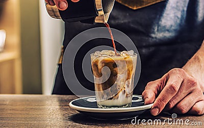 Close-up a barista making fres ice coffee on barcounter Stock Photo