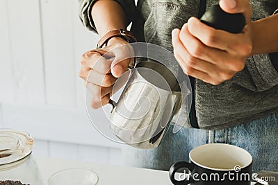 Close- up .Barista is steaming, milk frother latte art in coffee mug at home in the morning Stock Photo