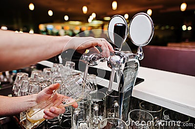 Close up of barman hand at beer tap Stock Photo