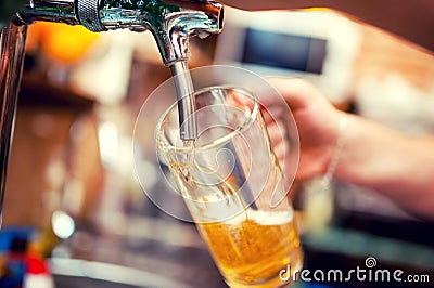 Close-up of barman hand at beer tap pouring a draught beer Stock Photo