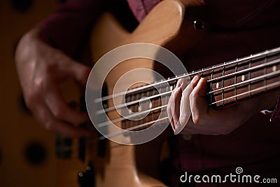 Close Up Of Bass Guitarist Playing Instrument Stock Photo