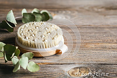 Dry massage brush close-up on a wooden background. Stock Photo