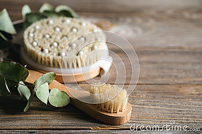 Dry massage brushes close-up on a wooden background. Stock Photo