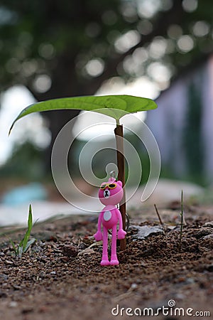 Close Up of bauble hanging from a decorated leaves background Stock Photo