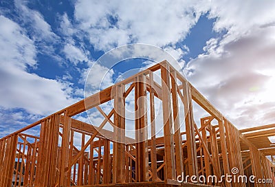 Close-up of beam built home under construction and blue sky with wooden truss, post and beam framework. Timber frame house, real Stock Photo