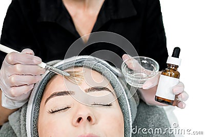 Close up of beautician cosmetologist applying chemical peel treatment on patient in a beauty spa, for skin rejuvenation, Stock Photo