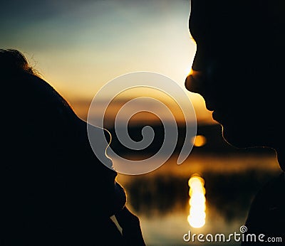 Close-up of beautiful emotional bride holding face of handsome groom, newlywed couple looking into each other eyes Stock Photo