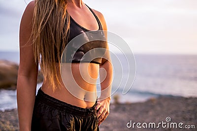 Close up of beautiful female belly with abdominal muscles - concept of healthy lifestyle and helath body care people - caucasian Stock Photo