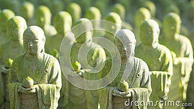 Close up of beautiful many monk stone statue with moss and sun Stock Photo