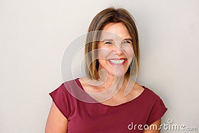 Close up beautiful middle age woman smiling against white wall Stock Photo