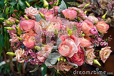 Close-up of beautiful multi-colored bouquet of mixed roses and other flowers in a shop. Fresh cut flowers Stock Photo