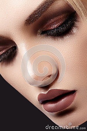 Close-up of Beautiful Woman Face. Fashion Evening Make-up, Glitter Eyeshadows, Matt Lips, Shiny Clean Skin. Sexy Style Stock Photo
