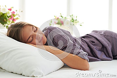Close-up of beautiful woman in satin pajamas sleeping peacefully Stock Photo