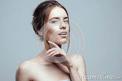 Close-up beautiful young woman with clean fresh skin touch her face. Natural beauty and spa Stock Photo