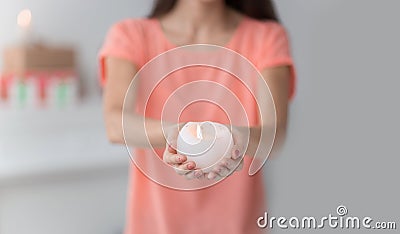 Close up.a beautiful young woman extends a burning candle Stock Photo