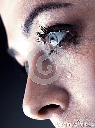 Close up of beauty girl cry on black background Woman with tear on face Stock Photo