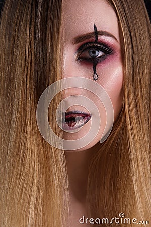 Close-up beauty portrait of a girl with a creative make-up. Scary and creepy halloween concept. Stock Photo