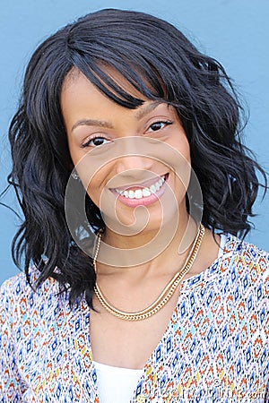 Close up beauty portrait of a young and attractive African American black woman with perfect skin, softly smiling Stock Photo