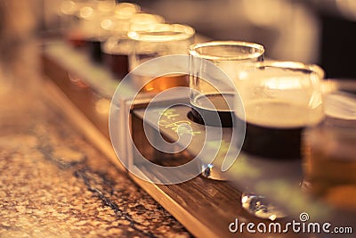 Close up of beer flights on granite bar top with selective focus Stock Photo