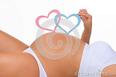 Close-up belly of pregnant woman. Gender: boy, girl or twins? Stock Photo