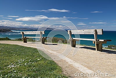 Close up on benches on coastal footpath cliff, relaxation concept, admiring scenic aerial view on atlantic coastline, bidart, fran Stock Photo