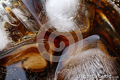 Close-up beverage cola and cubes ice refreshing cool in glass, black cola soda in glass with ice cubes for refreshments feel Stock Photo