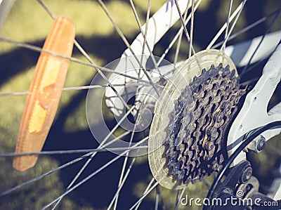 Close up of a Bicycle wheel with details, chain and gearshift mechanism, in morning sunlight Stock Photo