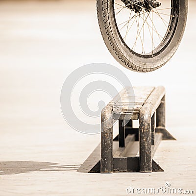 Close-up of bicycle wheels doing trick by rail Stock Photo