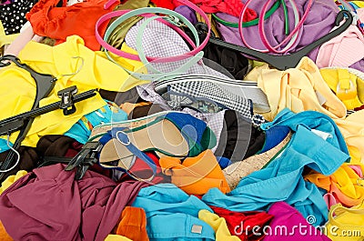 Close up on a big pile of clothes and accessories thrown on the ground. Stock Photo