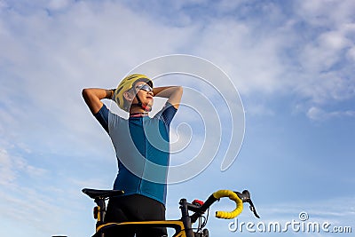 Close up of Biking cyclist man standing relax with bicycle in th Stock Photo