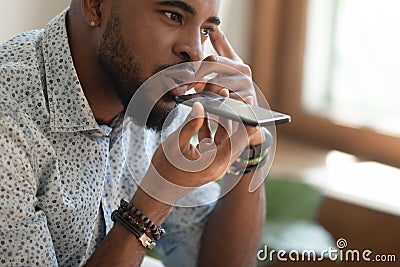 Close up of biracial male using cellphone voice assistant Stock Photo