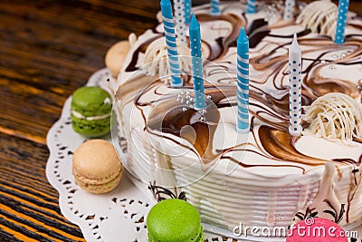 Close up of birthday cake with lots of candles near different co Stock Photo