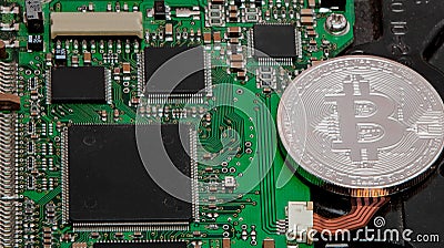 Close-up of bitcoin, computer circuit board with bitcoin processor and microchips. Electronic currency, internet finance rypto cur Stock Photo