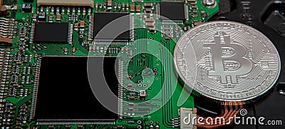 Close-up of bitcoin, computer circuit board with bitcoin processor and microchips. Electronic currency, internet finance rypto cur Stock Photo