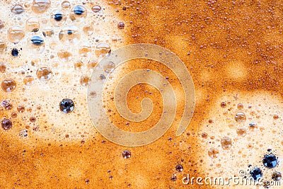 Close up black coffee crema foam texture background. Stock Photo