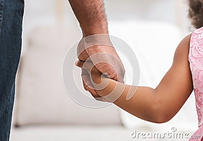 Close up of black father giving hand to his daughter Stock Photo