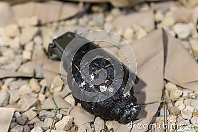 close up of an black grenade on ground .fragmentation grenade Stock Photo