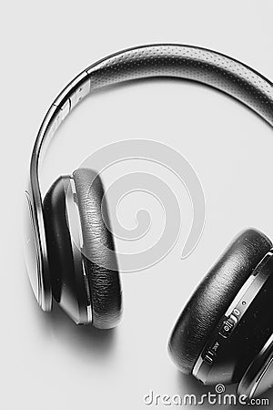 Close up of black headphones lying on a white table Stock Photo