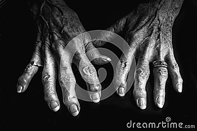 A close up black and white image of an elderly woman's arthritic hands. Stock Photo